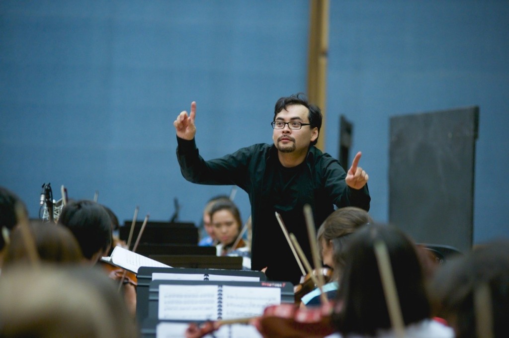 The conductor and orchestra rehearse for the "Abai" premiere. 