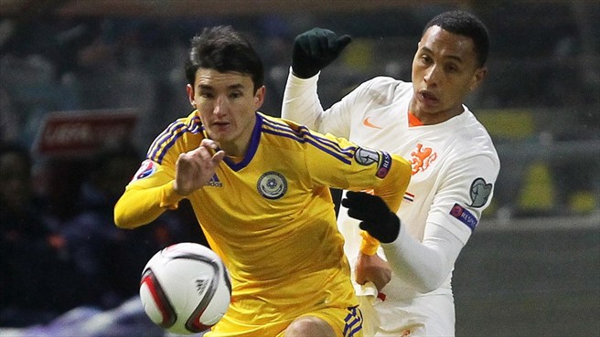 Ulan Konysbaev holds off Kenny Tete as Kazakhstan struggle to contain the visitors PHOTO uefa.com
