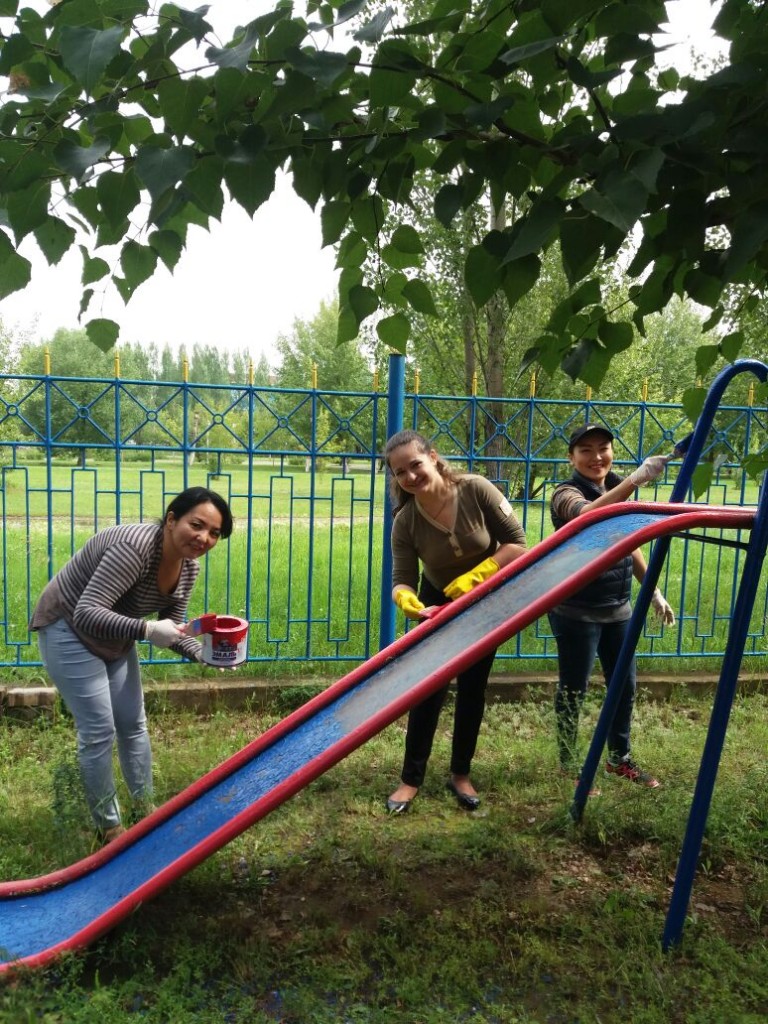 South African Embassy staff busy painting at the playground of the SOS Children's Village