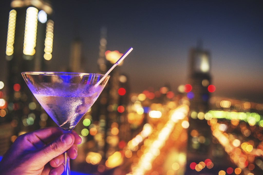 martini drink with city lights of Dubai downtown