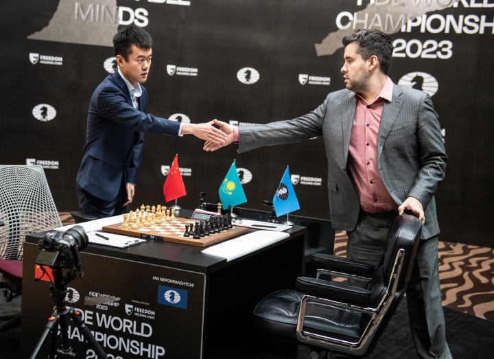 China's Ding Liren, left, and Russia's Ian Nepomniachtchi shake hands prior  to their FIDE World Chess Championship in Astana, Kazakhstan, Saturday,  April 29, 2023. Ian Nepomniachtchi and Ding Liren are facing off